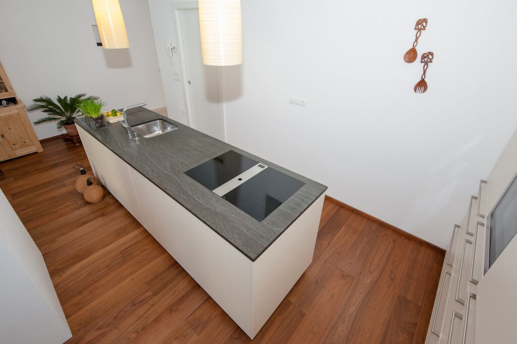 cucina ad isola e piano cottura con cappa integrata